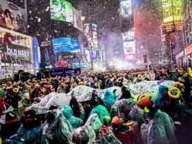 Times Square New Year's Eve Revelers Brave the Rain Without Umbrellas for Iconic Ball Drop